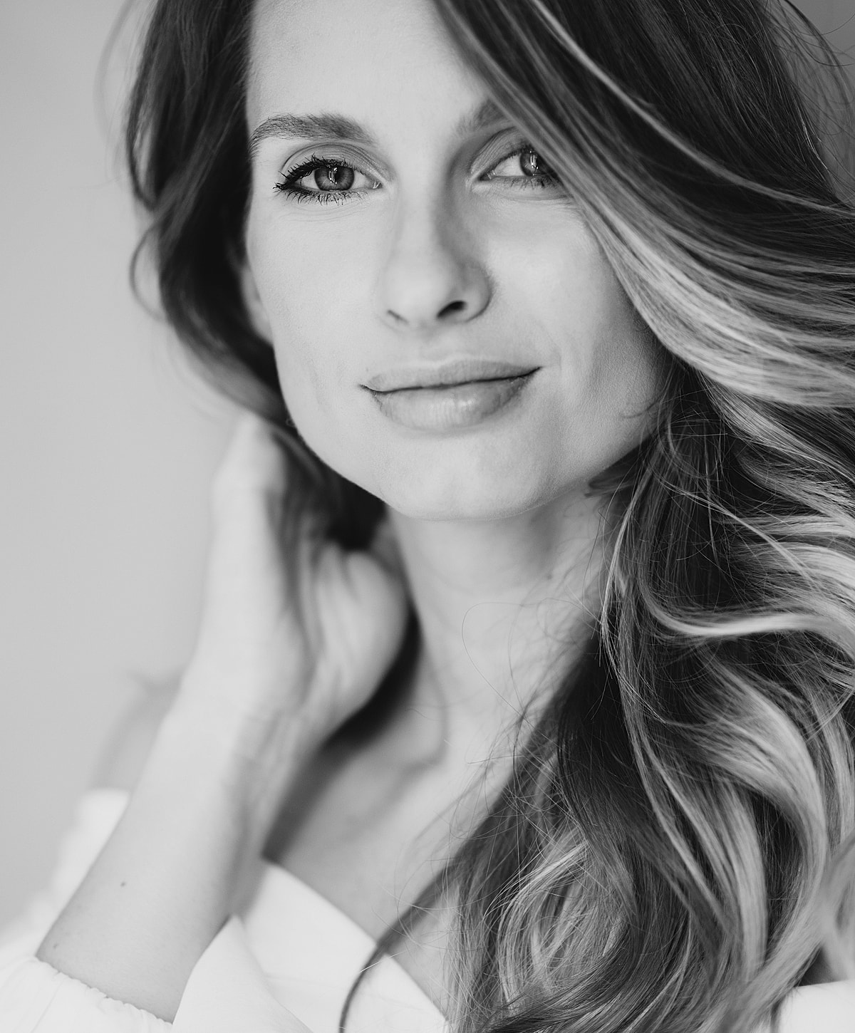 Black and white portrait of a smiling woman.