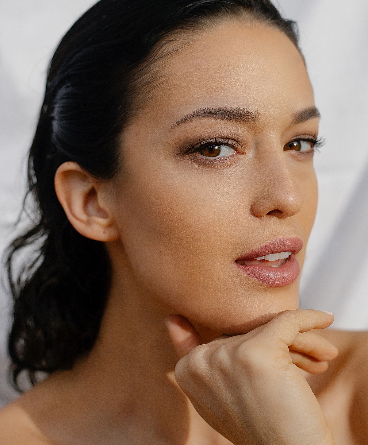 Close-up of a woman’s face, thoughtful expression.