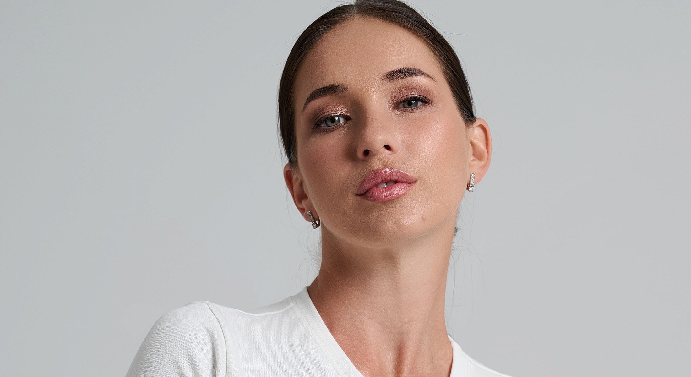 Portrait of a woman in a white shirt.