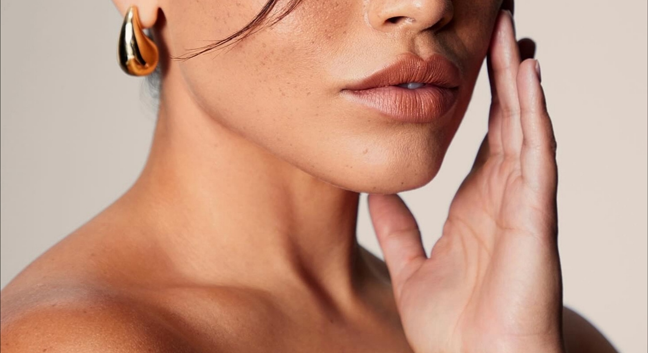 Close-up portrait of a woman with elegant earrings.